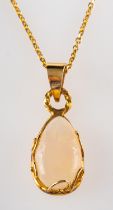 An opal pendant, the pear shaped cabochon opal in a scrolled setting, stamped 14k,