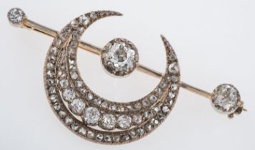 An Edwardian diamond set sun and moon brooch, set with old cut stones,
