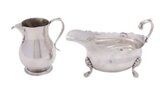 A silver cream jug by J. B.