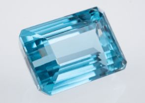 A Brazilian blue topaz of good colour, the step cut rectangular stone of around 23 carats.