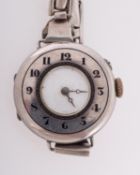 A lady's silver half-hunter wristwatch the white enamel dial with blued-steel moon hands,