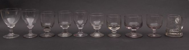 A mixed group of drinking glasses, primarily rummers, but with two wrythen moulded ale glasses,