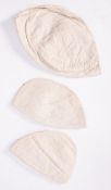 Three child's quilted cotton caps, each composed of three segments,