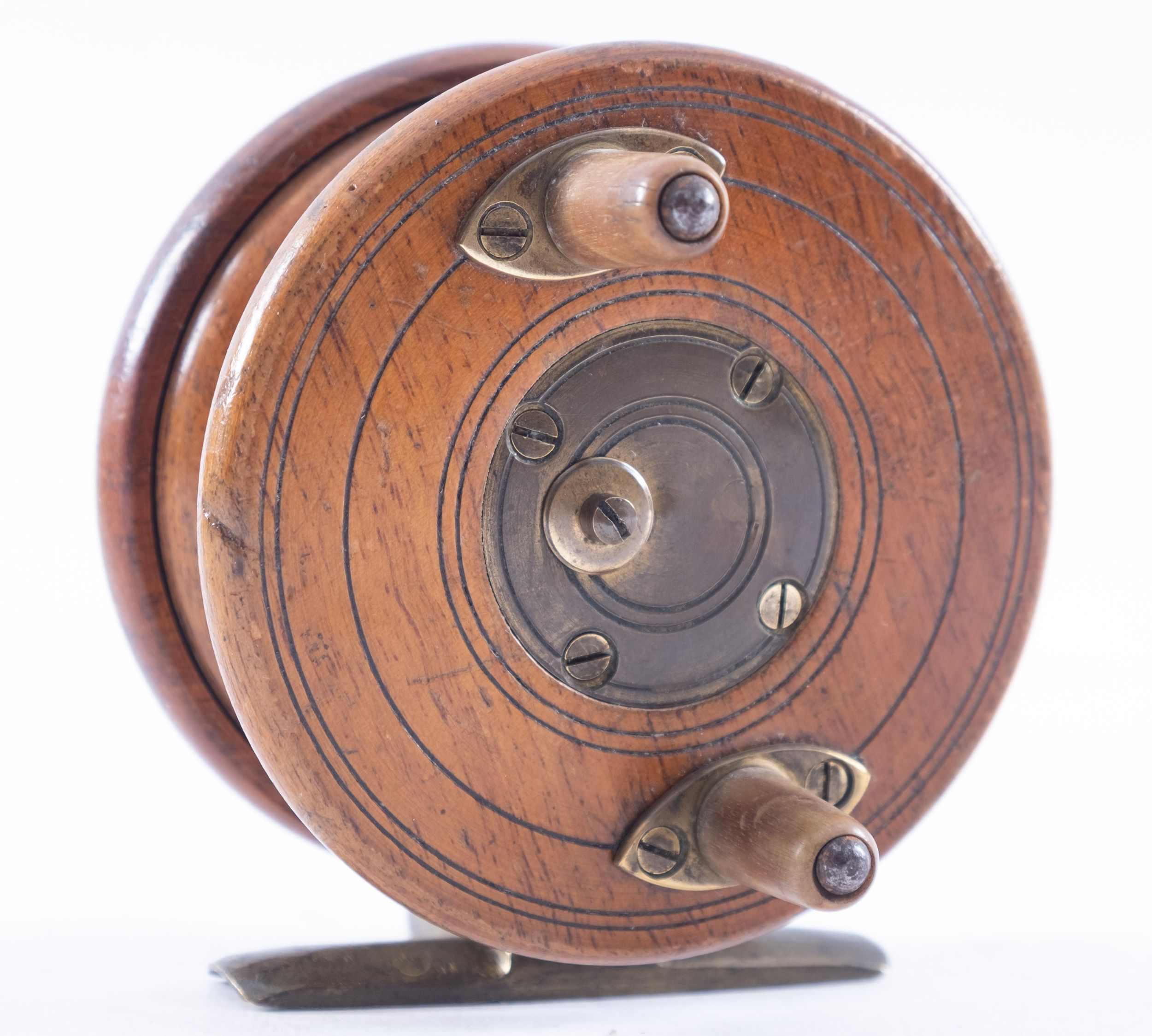 An Anglers Depot Nottingham star back 3 1/2inch fishing reel, mahogany and brass, twin horn handles,