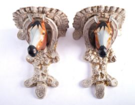 A pair of early 20th century Staffordshire pottery horse head wall brackets,