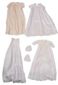 A collection of child's clothing items including two lacework christening gowns,