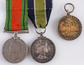 A WWII pair, consisting of Defence Medal and Colonial Police Long Service Medal,