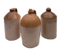 A group of three stoneware bottles, stamped 'Charles Glass Wine & Spirit Merchant Hatherleigh',