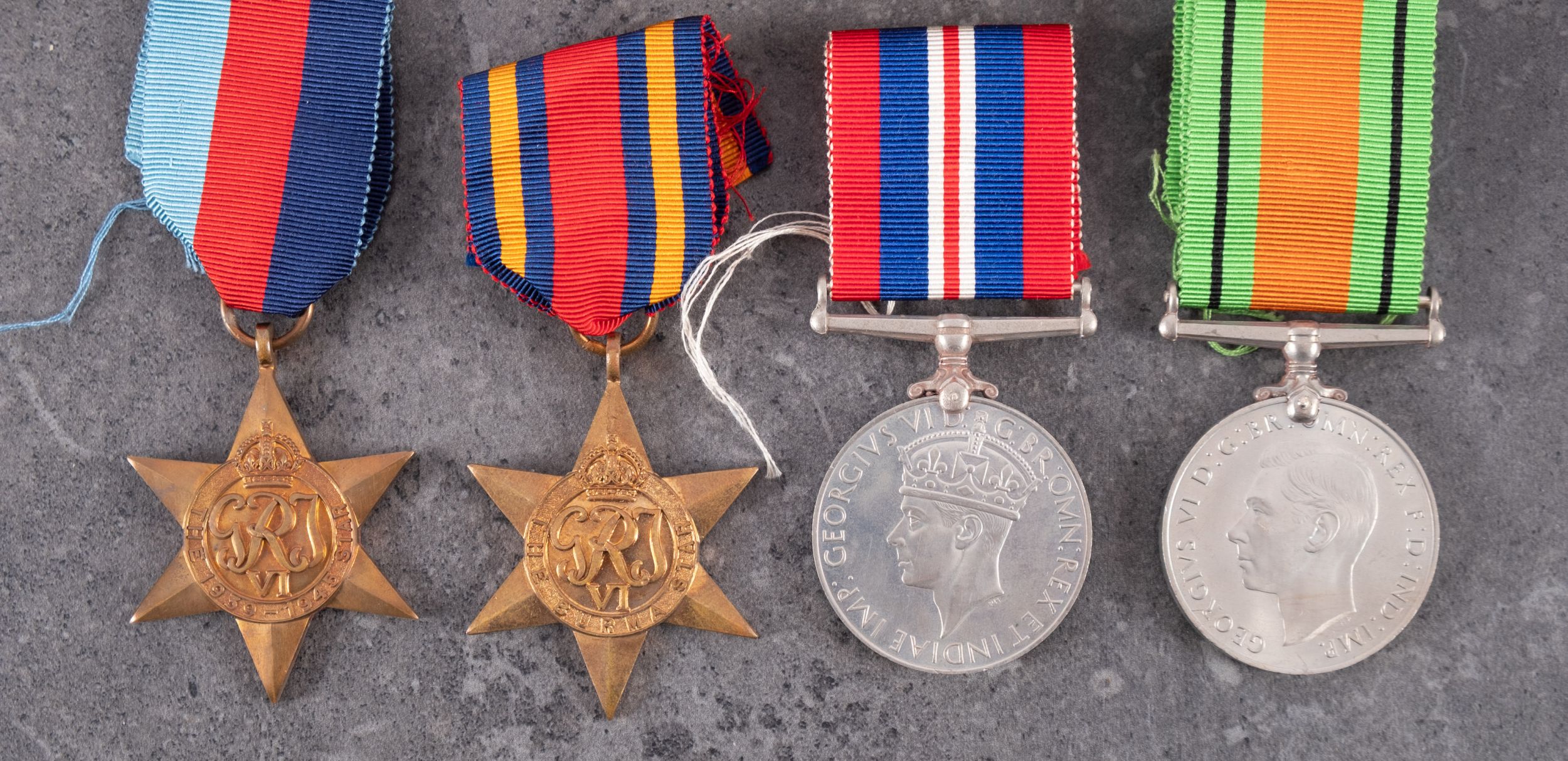 A collection of WWII service medals with postage boxes. - Image 2 of 3