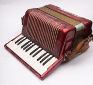 A Hohner Student II accordion, in red pearl finish, cased.