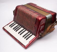 A Hohner Student II accordion, in red pearl finish, cased.