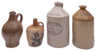 A group of four stoneware bottles, one stamped 'W&S Lucas Ltd Brewers & Spirit Merchants Hitchin',