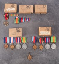 A collection of WWII service medals with postage boxes.