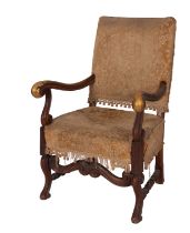 A carved walnut and upholstered elbow chair in William and Mary style,