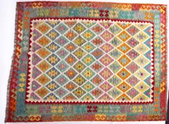 An Anatolian Turkish Kilim, the brightly coloured lozenge field in a variety of pastel shades,