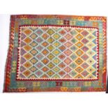 An Anatolian Turkish Kilim, the brightly coloured lozenge field in a variety of pastel shades,