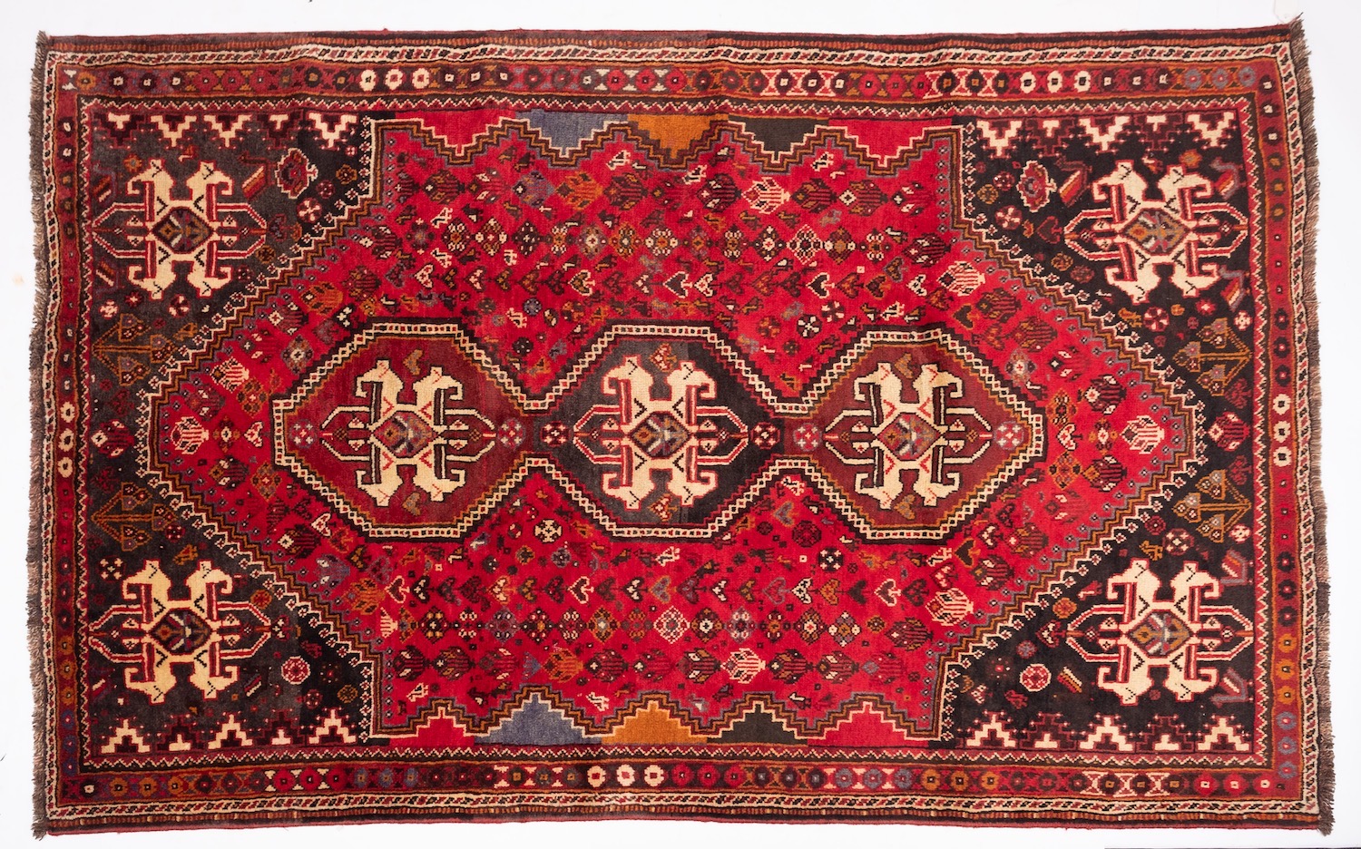 A Qashgai carpet, the rose field with triple hexagonal stepped central medallions, - Image 4 of 6