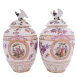 A pair of Berlin porcelain jars and covers of ribbed ovoid form with eagle finials,