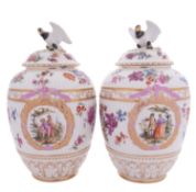 A pair of Berlin porcelain jars and covers of ribbed ovoid form with eagle finials,
