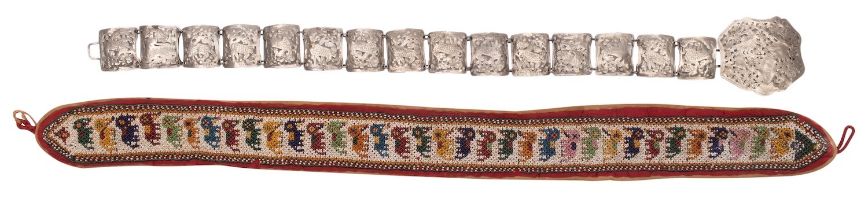An Indian beadwork belt and an Indonesian pierced white metal belt with buckle the first with a