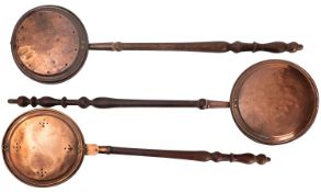 A collection of six various brass and copper warming pans,
