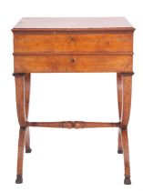 A Regency or George IV burr walnut work table, circa 1820; the hinged top with moulded edges,