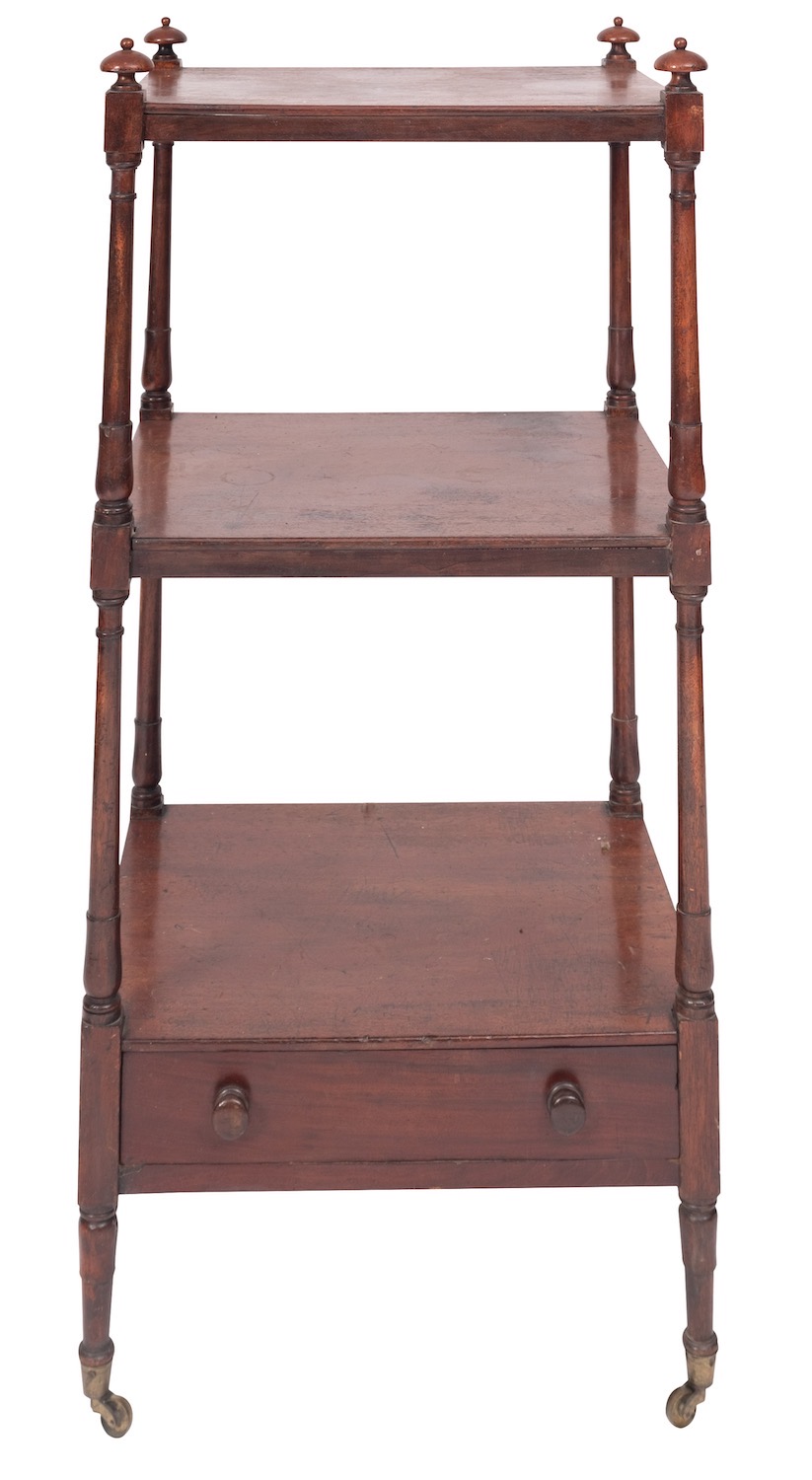 A Regency mahogany three tier etagere, early 19th century; with turned finials at the upper corners,