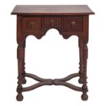 A Queen Anne or George I oak lowboy side table,