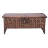 An oak coffer in Gothic style, 17th century and later carved; with hinged cover,