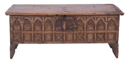 An oak coffer in Gothic style, 17th century and later carved; with hinged cover,