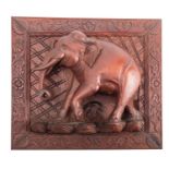 A carved and stained hardwood relief modelled with an elephant, probably South East Asian,