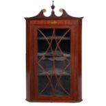 A George III mahogany and glazed hanging corner cabinet,