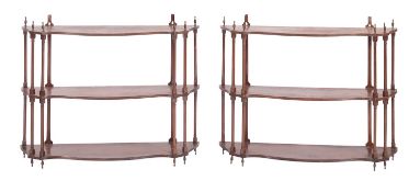 A pair of Regency mahogany sets of open wall shelves, early 19th century; each three tiered,