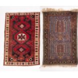 An Afghanistan rug, the shaded field with triple rose lozenge pointed medallions,