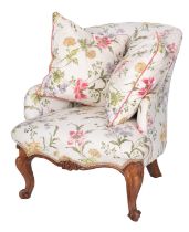 A carved walnut and upholstered armchair in Louis XV taste,