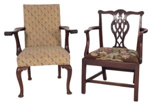 A George III mahogany and upholstered library elbow chair in Chippendale style,