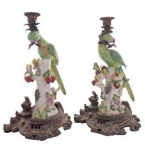 A pair of reproduction ceramic and gilt-metal mounted parrot candlesticks, 37cm.