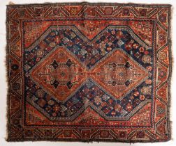 A Hamadan rug, the indigo field with twin brown serrated lozenge medallions,