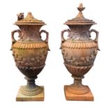 A pair of substantial faux terracotta garden urns with covers,