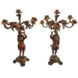 A pair of bronze and later cold painted figural six light candelabra,
