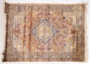 A Kashmir rug, the brick red cartouche field with a central indigo and ivory pole medallion,