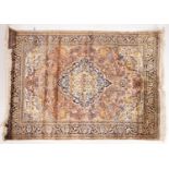 A Kashmir rug, the brick red cartouche field with a central indigo and ivory pole medallion,