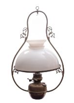 A late Victorian brass and milk glass hanging oil lamp, circa 1900; the domed shade with open vent,