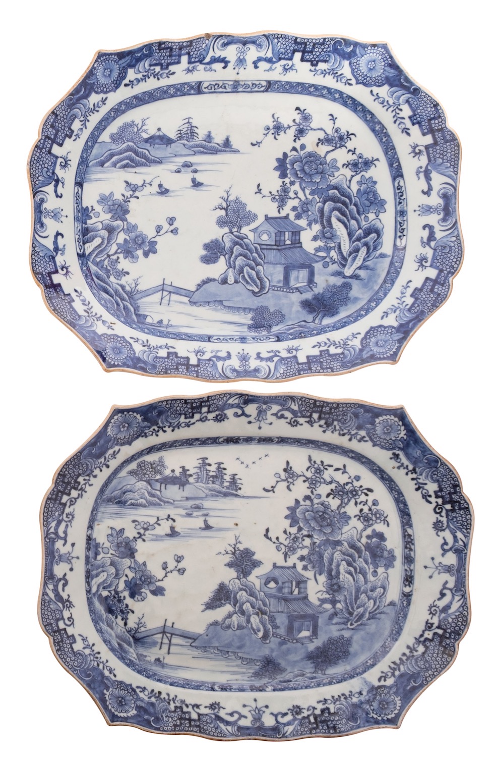 A pair of Chinese blue and white shaped rectangular meat dishes each painted with pavilions in a