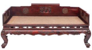 A Chinese carved and stained hardwood and rattan day bed,