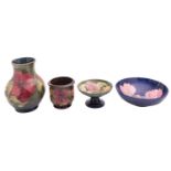 Four pieces of Walter and John Moorcroft pottery comprising a vase,