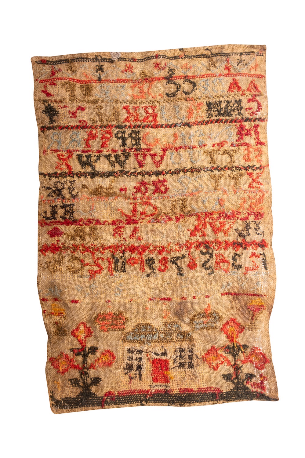 An early 19th century sampler, with alphabet in multi-colours, above a house flanked by flowers, - Image 3 of 4