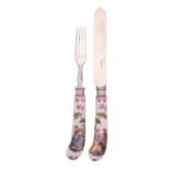 A pair of German porcelain knife and fork handles painted in the Meissen manner with lovers in