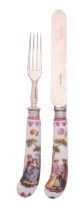 A pair of German porcelain knife and fork handles painted in the Meissen manner with lovers in