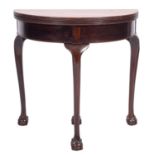A George III mahogany demi-lune tea table, late 18th century; the hinged top with reeded edges,